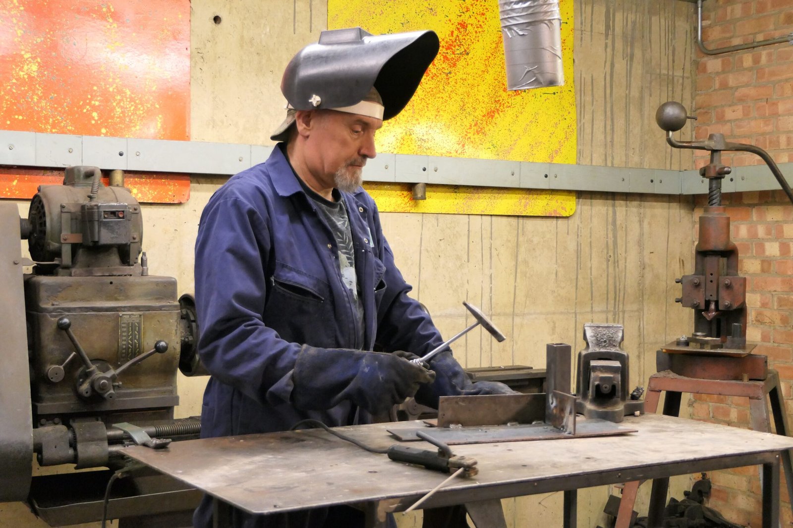 a man working on a machine in a factory